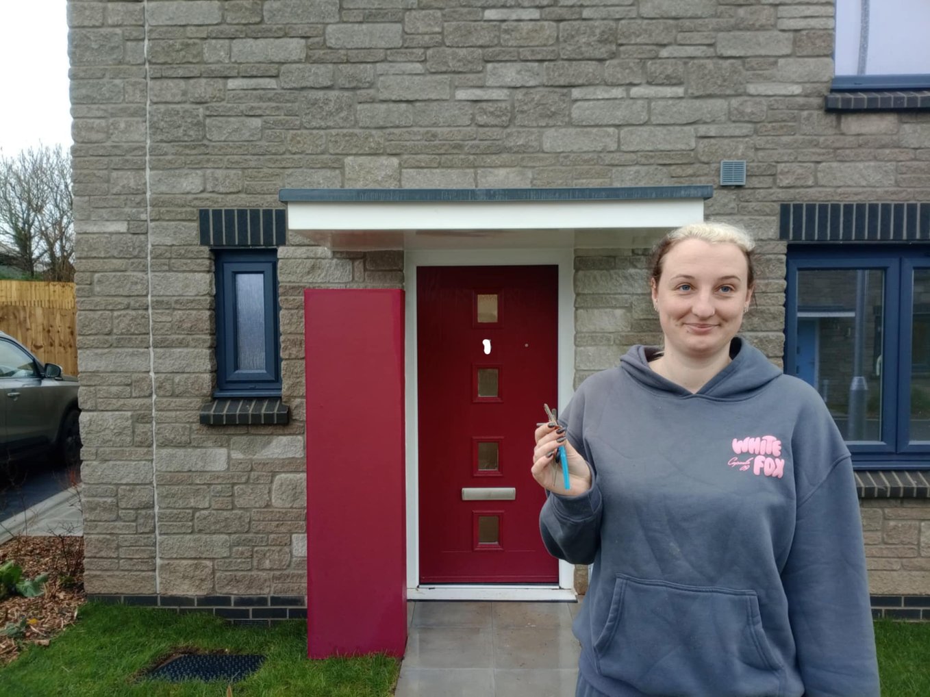 Melissa shows off the keys to her new home