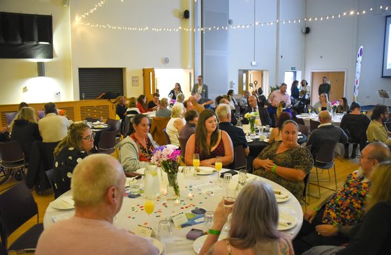 Whole room shot of guests seated